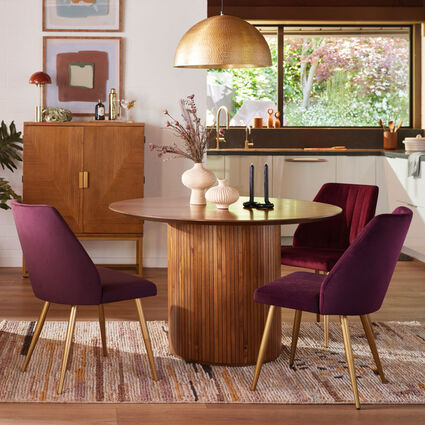 An eat-in kitchen featuring a dining area with a small round table