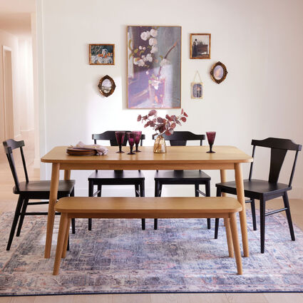 A gallery wall above a dining area