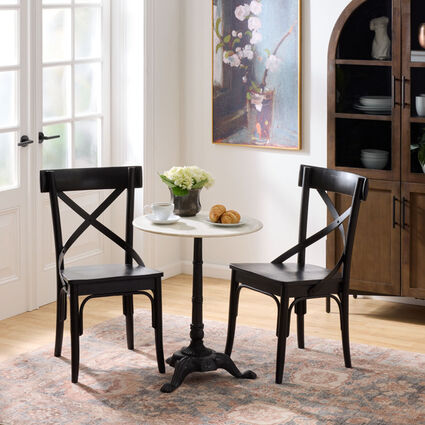A small round bistro table and two chairs