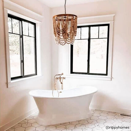 White bathroom with wooden beaded chandelier over garden tub
