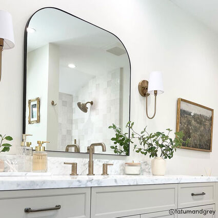 White bathroom with MIra arched vanity mirror in black frame above sink