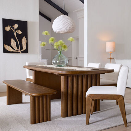 A distinctive pendant light above a small dining area