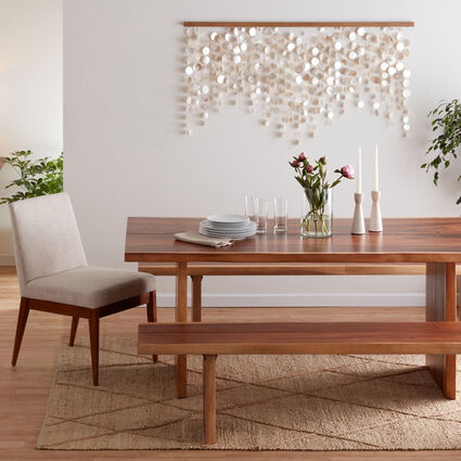 A wooden dining table with benches that tuck under