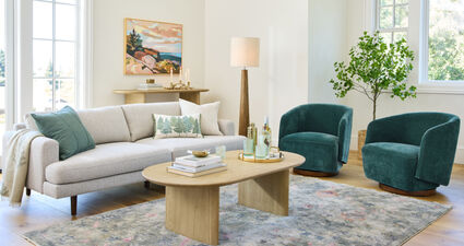 White sofa, green chaits, blonde wood coffee table