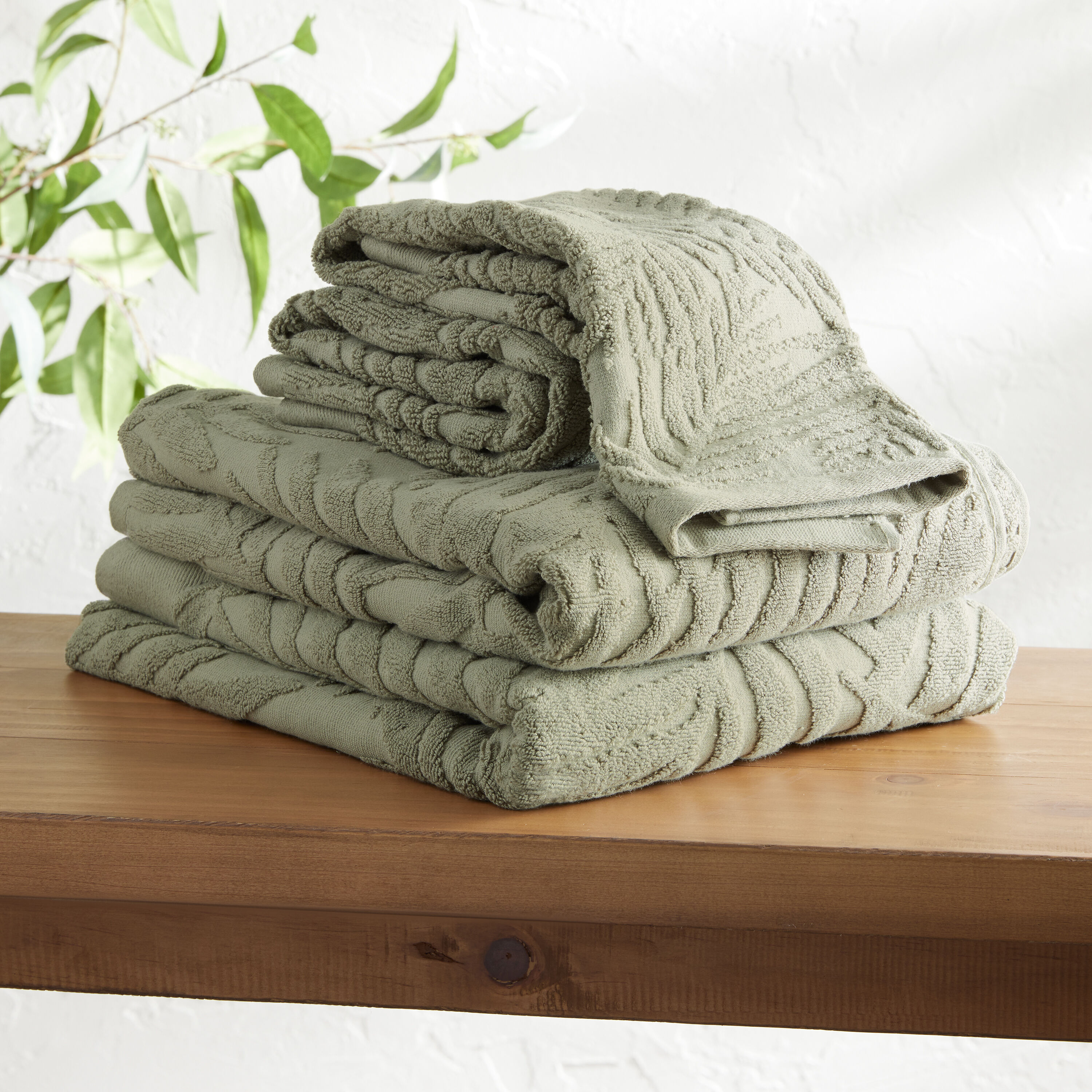 Sage green towels and store bathmats